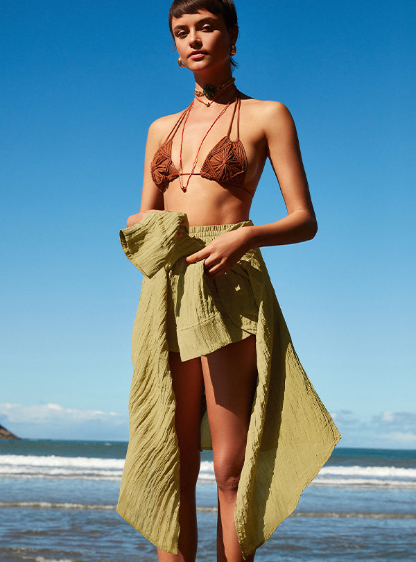 woman in brown bikini and green shorts on the beach